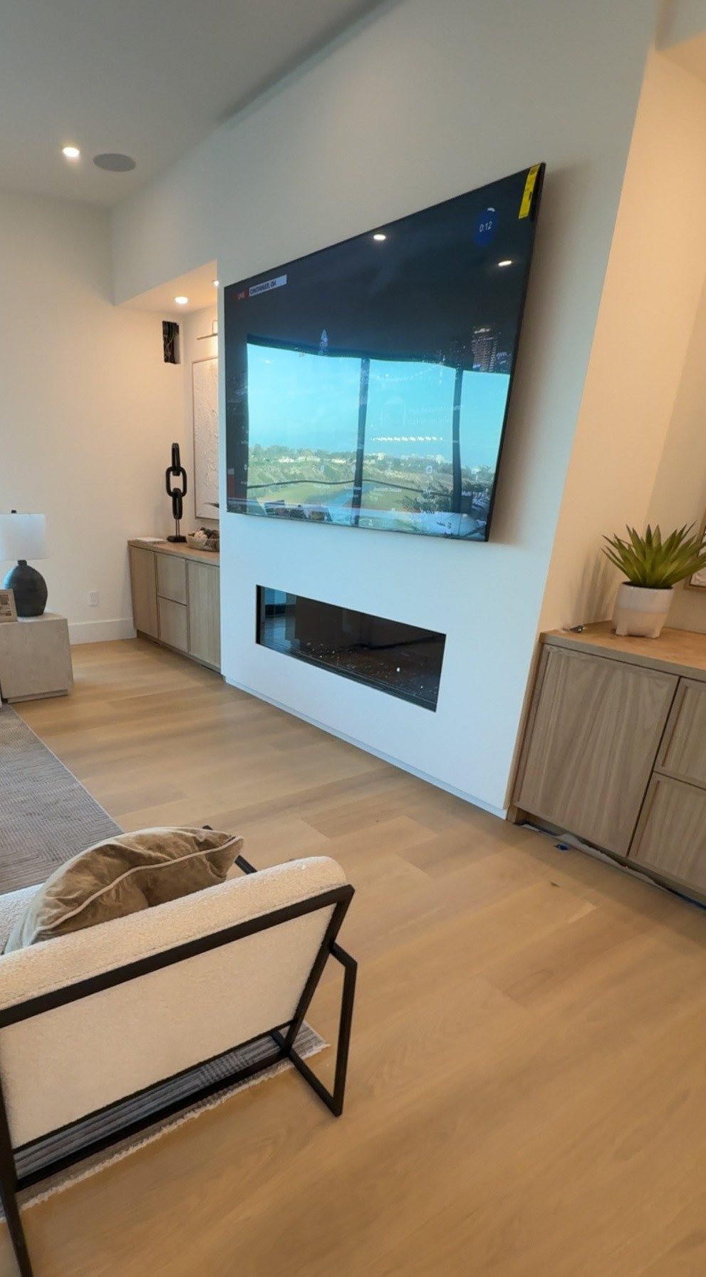TV mount over fireplace — luxury living room, Orange County