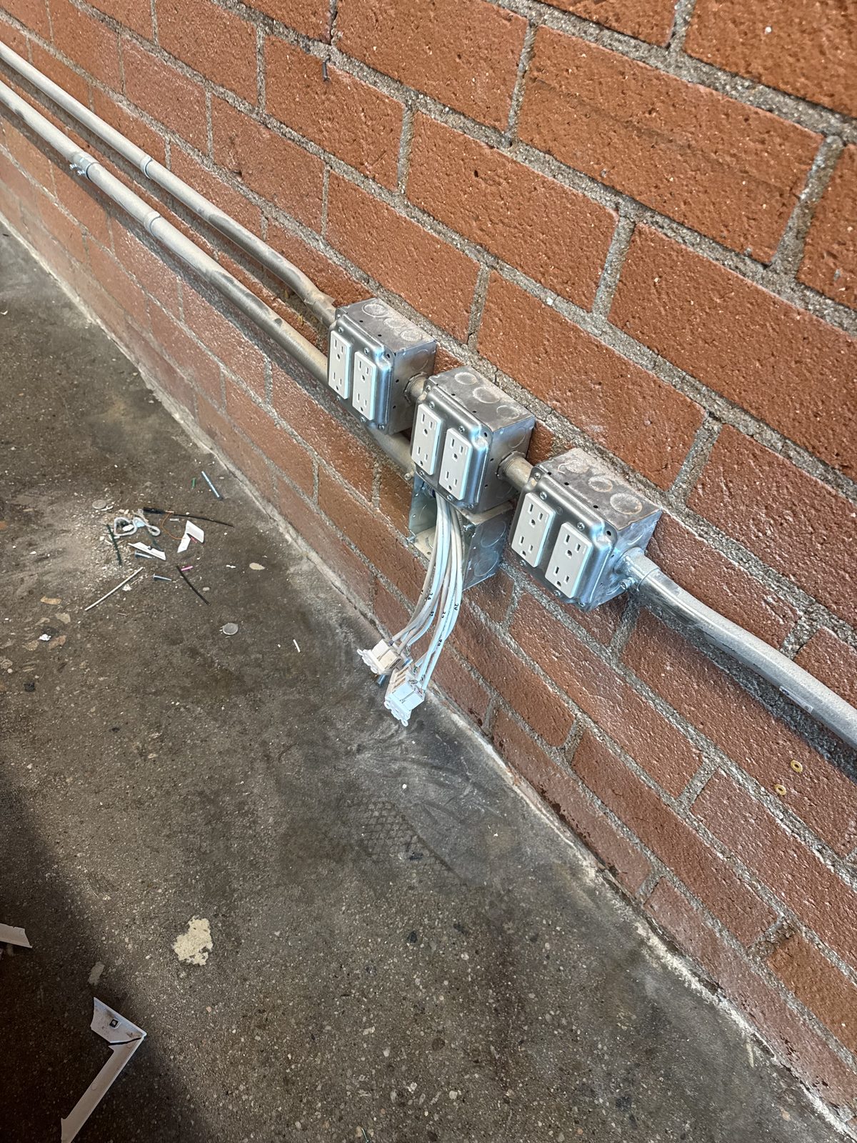 Commercial conduit and electrical outlets — brick building